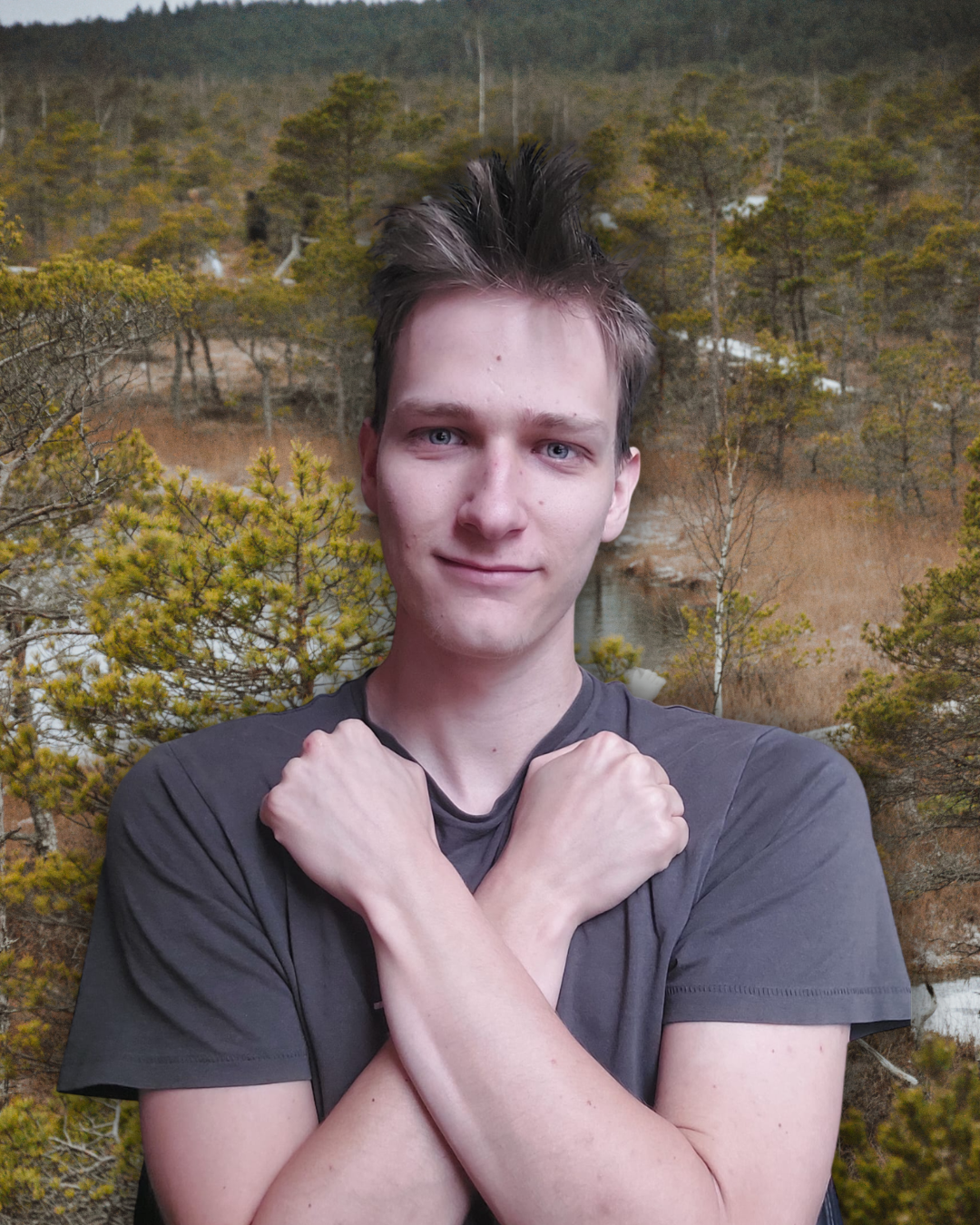 Edgars standing with crossed arms in a quiet forest landscape